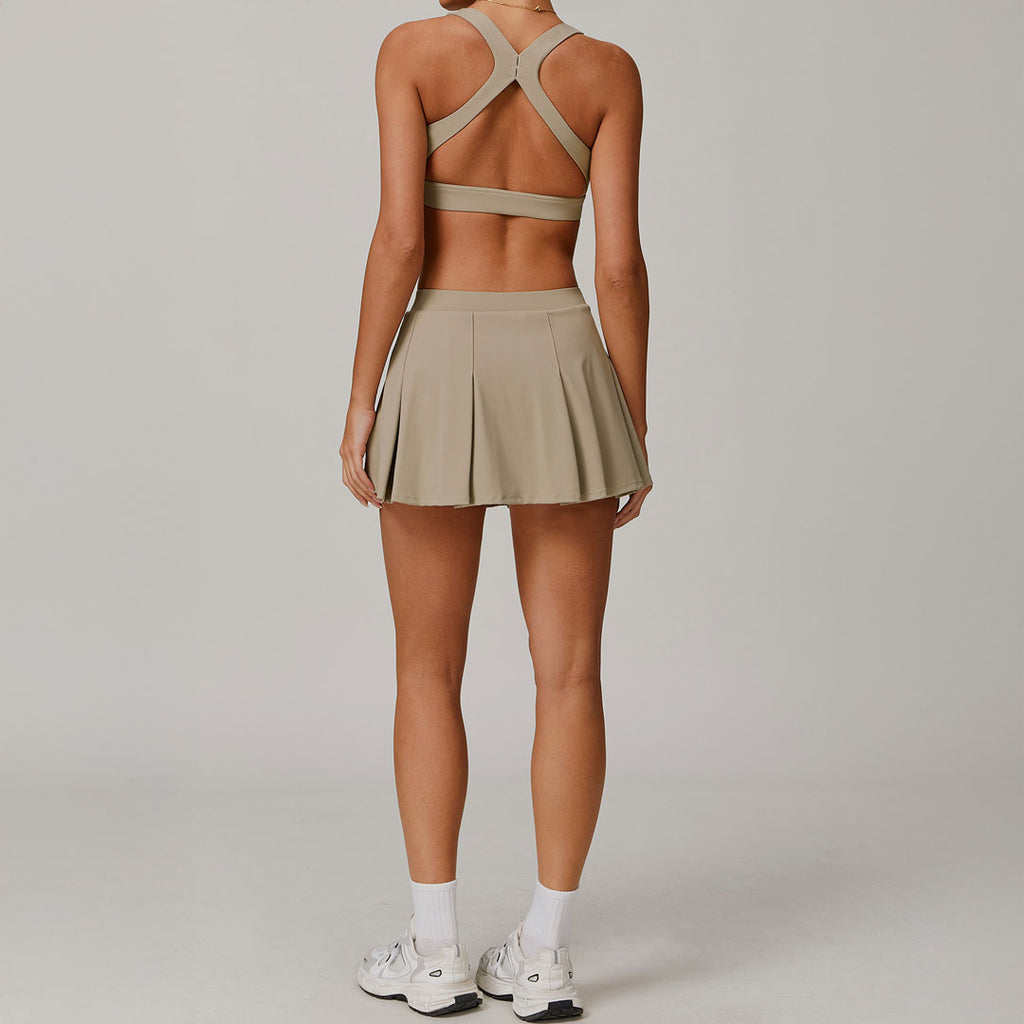 Mujer luciendo un conjunto deportivo de falda y sports bra cruzado khaki 