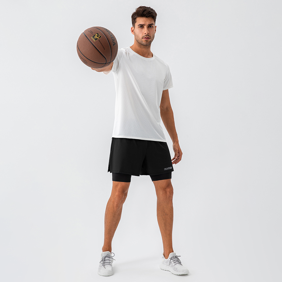 Hombre luciendo short deportivo negro y camisa blanca